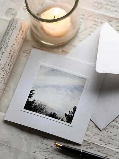 Trauerkarte mit Himmelmotiv, weiter Himmel mit Wolken und Baumsilhouetten